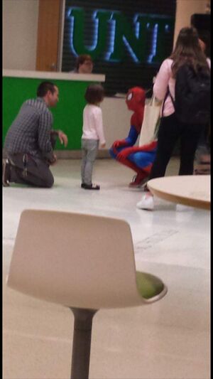 Spiderman greets a young visitor to UNT